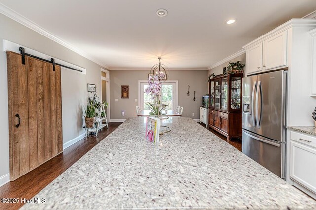 22 Calhoun Ln, Pinehurst, NC 28374 - kitchen featuring stainless steel fridge, dark wood-type flooring, white cabinetry, light stone countertops, and crown molding