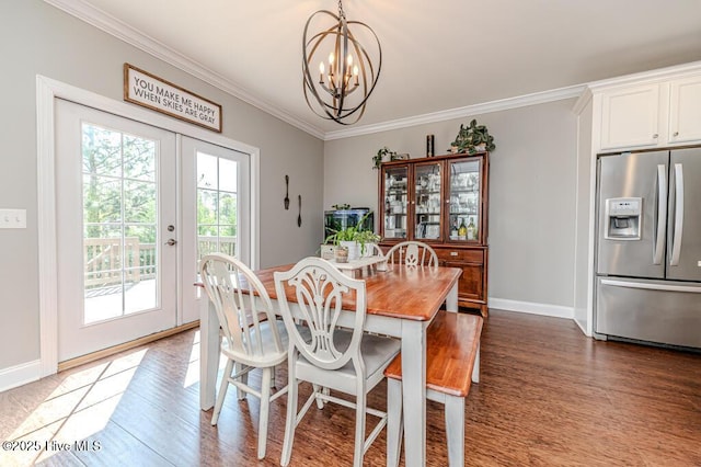 22 Calhoun Ln, Pinehurst, NC 28374 - dining area featuring a chandelier, wood finished floors, ornamental molding, baseboards, and french doors