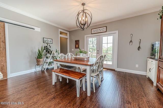 22 Calhoun Ln, Pinehurst, NC 28374 - dining area with a chandelier, ornamental molding, dark wood-type flooring, baseboards, and french doors
