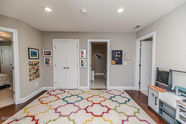 22 Calhoun Ln, Pinehurst, NC 28374 - bedroom with baseboards, dark wood-style floors, recessed lighting, and a closet