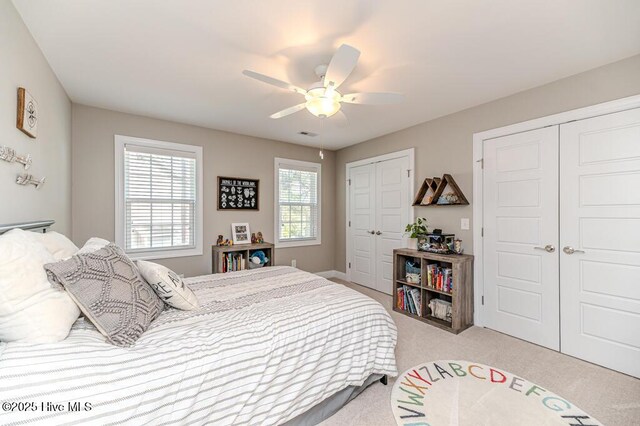 22 Calhoun Ln, Pinehurst, NC 28374 - bedroom featuring two closets, light colored carpet, and ceiling fan