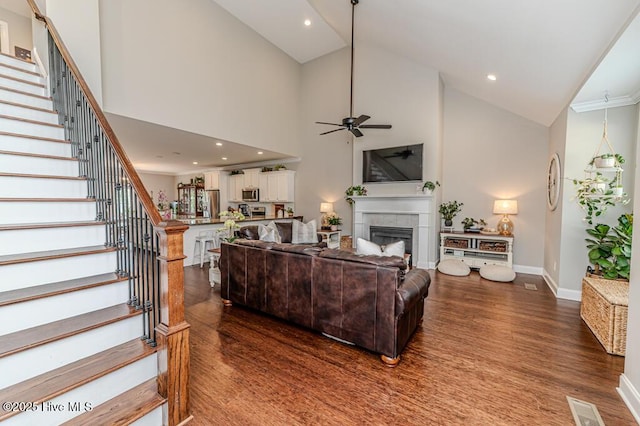 22 Calhoun Ln, Pinehurst, NC 28374 - living room featuring ceiling fan, stairway, dark wood-style flooring, high vaulted ceiling, and baseboards