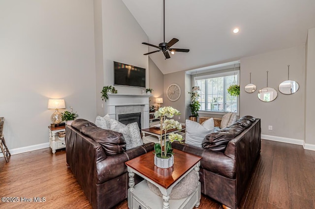 22 Calhoun Ln, Pinehurst, NC 28374 - living room featuring wood finished floors, baseboards, a ceiling fan, a tile fireplace, and high vaulted ceiling