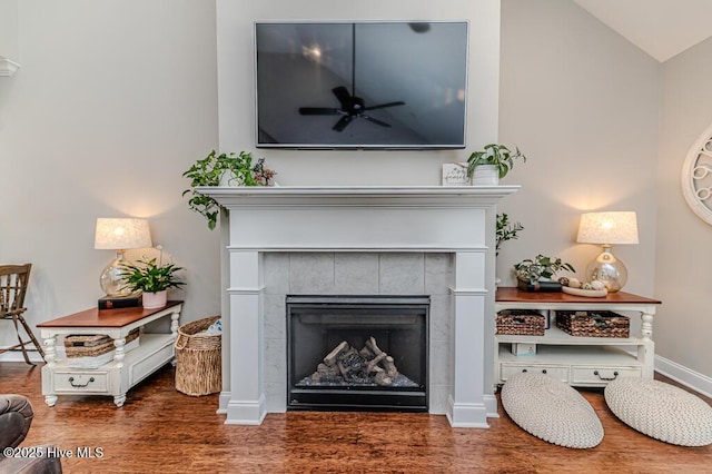 22 Calhoun Ln, Pinehurst, NC 28374 - detailed view of a ceiling fan, a tile fireplace, wood finished floors, and baseboards