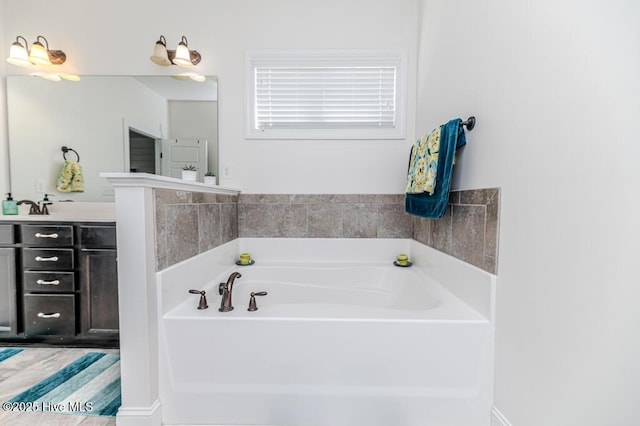 full bathroom with vanity and a garden tub