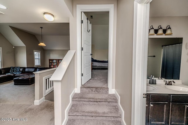stairs with baseboards, carpet flooring, and lofted ceiling