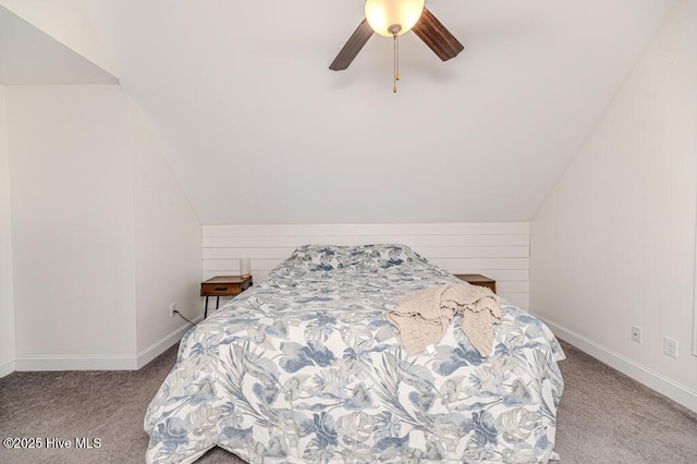 bedroom with baseboards, carpet flooring, and lofted ceiling