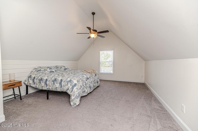 carpeted bedroom featuring ceiling fan, baseboards, and lofted ceiling
