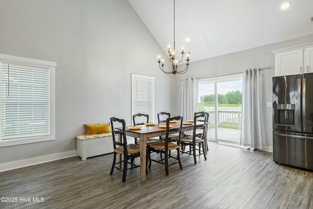 144 Pelican Pointe Dr, Elizabeth City, NC 27909 - dining space with a chandelier, high vaulted ceiling, dark wood finished floors, and baseboards