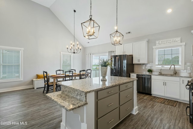 144 Pelican Pointe Dr, Elizabeth City, NC 27909 - kitchen with a sink, black fridge with ice dispenser, a notable chandelier, dishwashing machine, and a kitchen island