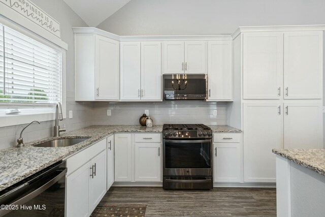 144 Pelican Pointe Dr, Elizabeth City, NC 27909 - kitchen with tasteful backsplash, white cabinets, a sink, stainless steel appliances, and vaulted ceiling