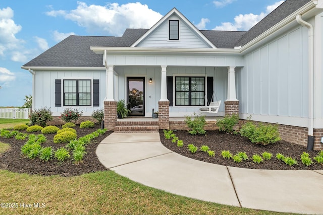 144 Pelican Pointe Dr, Elizabeth City, NC 27909 - view of front of house with roof with shingles, covered porch, and board and batten siding