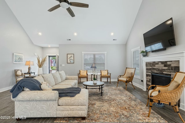 144 Pelican Pointe Dr, Elizabeth City, NC 27909 - living room with wood finished floors, ceiling fan, a fireplace, baseboards, and high vaulted ceiling