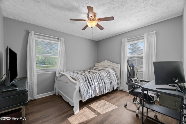bedroom featuring baseboards, a ceiling fan, a textured ceiling, and wood finished floors