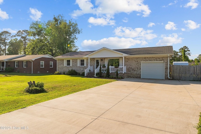 ranch-style home featuring covered porch, brick siding, a front lawn, concrete driveway, and an attached garage