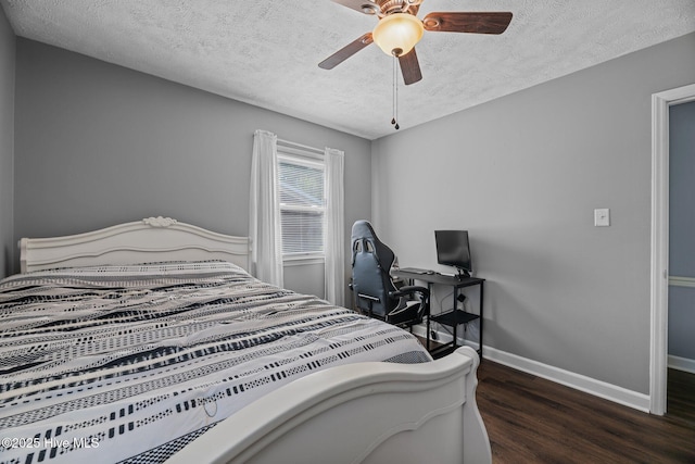 bedroom featuring baseboards, a textured ceiling, ceiling fan, and wood finished floors