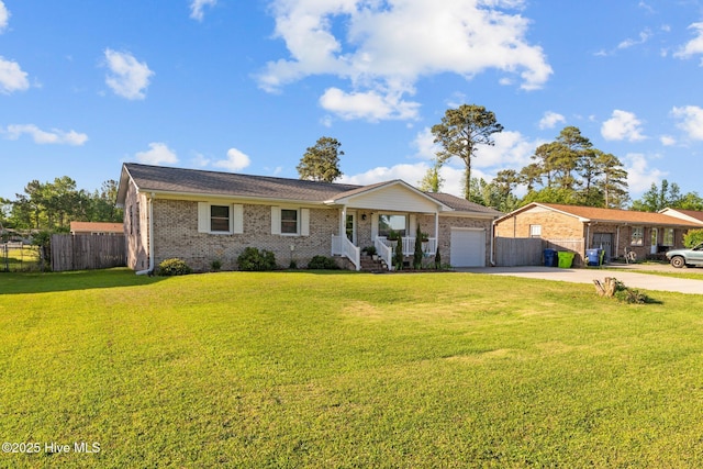 single story home with fence, an attached garage, driveway, and a front yard