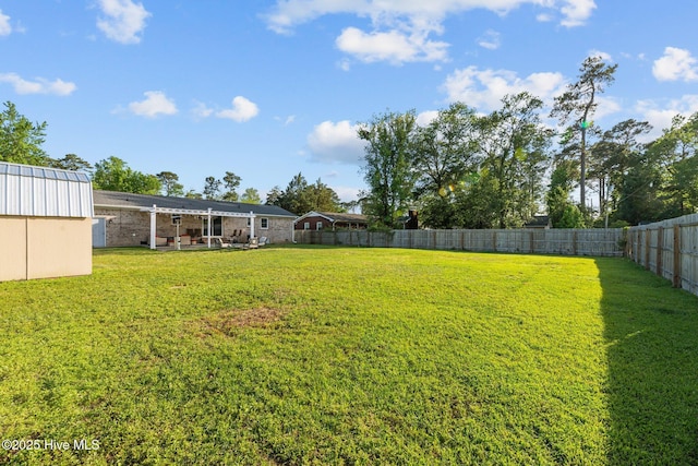 view of yard with a fenced backyard