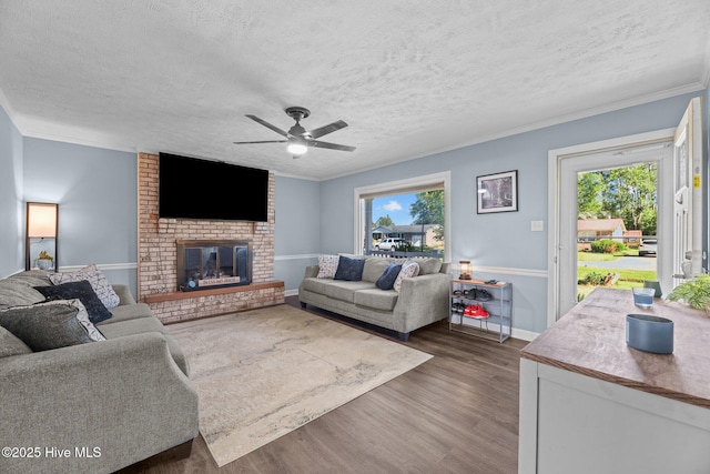living area featuring plenty of natural light, dark wood-style flooring, and a textured ceiling
