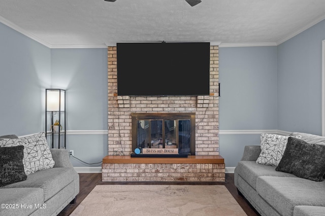 living area with baseboards, ornamental molding, dark wood-style flooring, and a fireplace