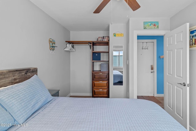 bedroom with baseboards and ceiling fan