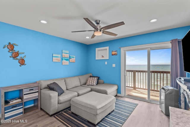 living area with ceiling fan, recessed lighting, and wood finished floors