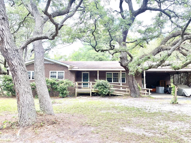 129 Cape Fear Dr, Southport, NC 28461 - rear view of house featuring brick siding and a carport