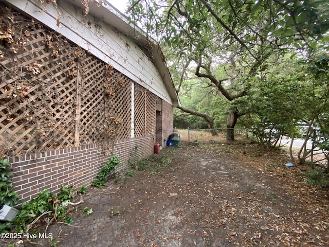 129 Cape Fear Dr, Southport, NC 28461 - view of side of property with fence and brick siding