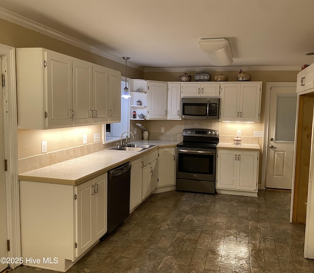 129 Cape Fear Dr, Southport, NC 28461 - kitchen featuring stainless steel appliances, a sink, white cabinets, light countertops, and brick patterned flooring
