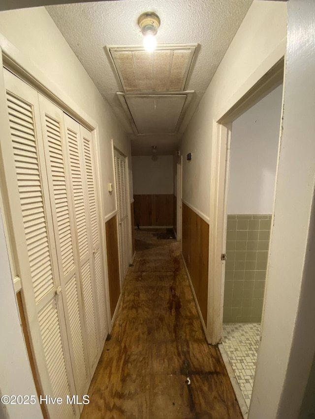 129 Cape Fear Dr, Southport, NC 28461 - corridor with attic access, a wainscoted wall, and a textured ceiling