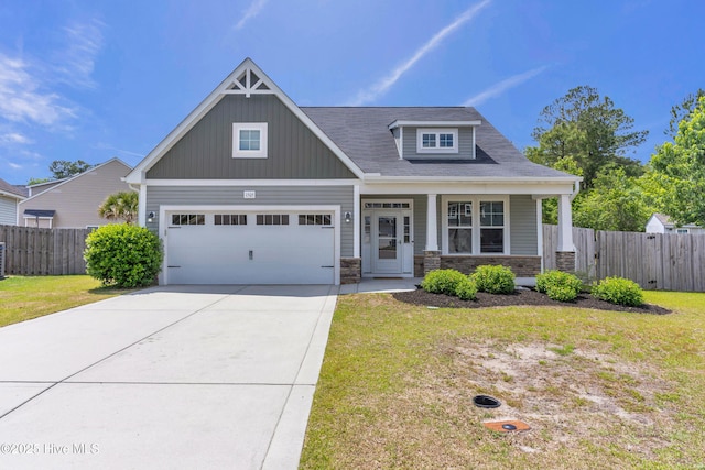 craftsman house featuring stone siding, driveway, a garage, a porch, and board and batten siding