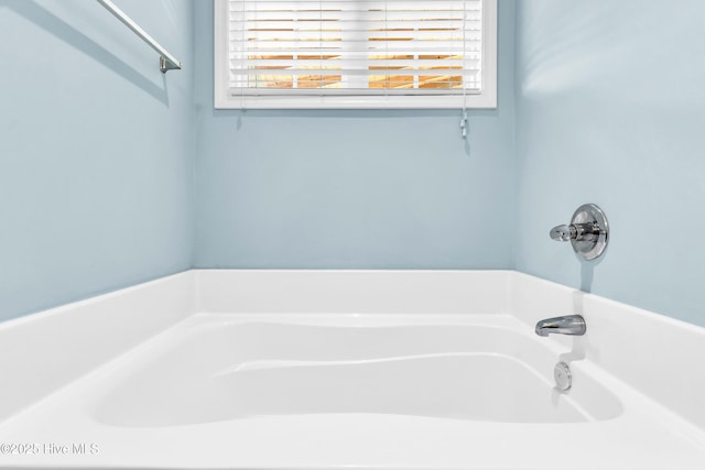 full bathroom featuring plenty of natural light and a bathtub