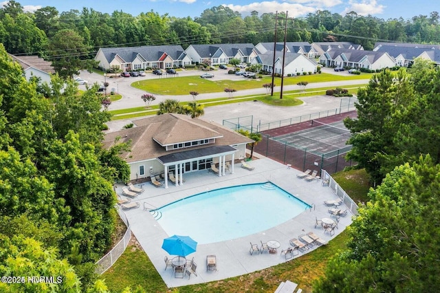 community pool with a residential view and a patio