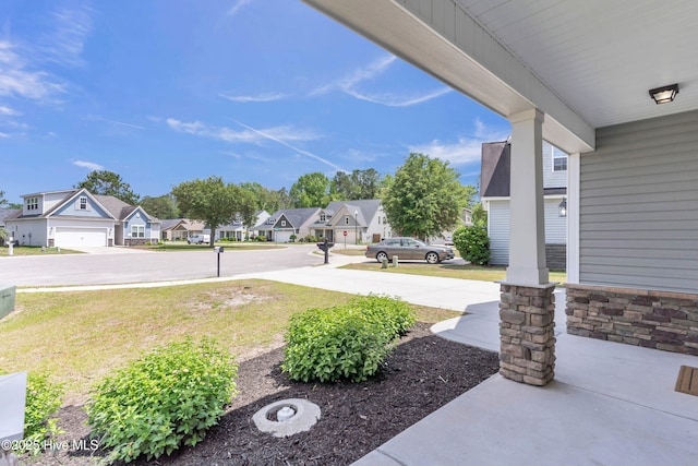 view of green lawn with a residential view