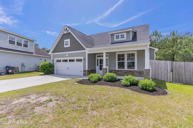 craftsman-style home with concrete driveway, stone siding, a porch, and an attached garage