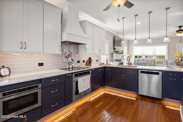 1 Gatha Ln, Ocean Isle Beach, NC 28469 - kitchen featuring a sink, open floor plan, premium range hood, a ceiling fan, and appliances with stainless steel finishes