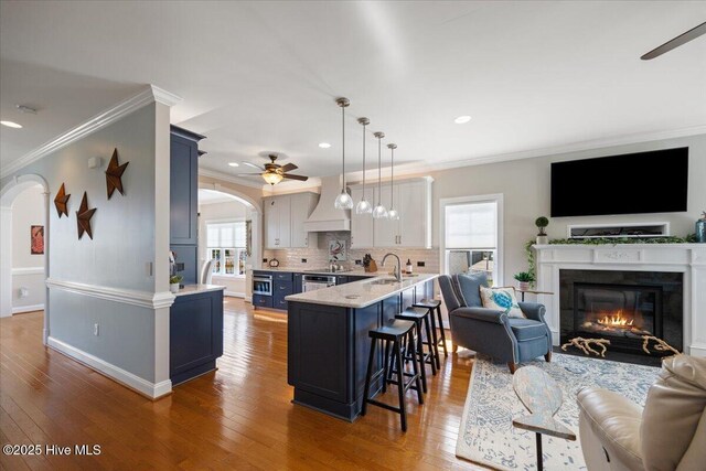 1 Gatha Ln, Ocean Isle Beach, NC 28469 - kitchen with a ceiling fan, arched walkways, open floor plan, and ornamental molding