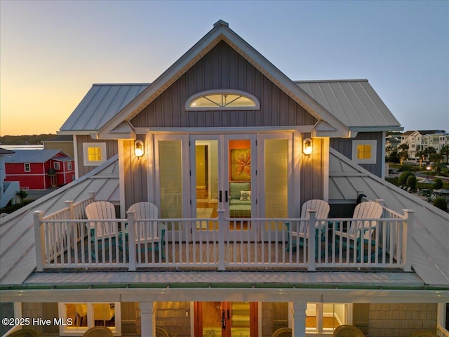 1 Gatha Ln, Ocean Isle Beach, NC 28469 - rear view of property with french doors, board and batten siding, a standing seam roof, and metal roof