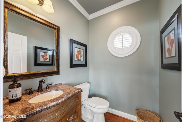 1 Gatha Ln, Ocean Isle Beach, NC 28469 - bathroom featuring crown molding, vanity, wood finished floors, toilet, and baseboards