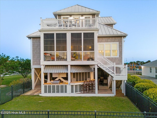 1 Gatha Ln, Ocean Isle Beach, NC 28469 - rear view of property with stairway, a standing seam roof, a fenced backyard, and a sunroom