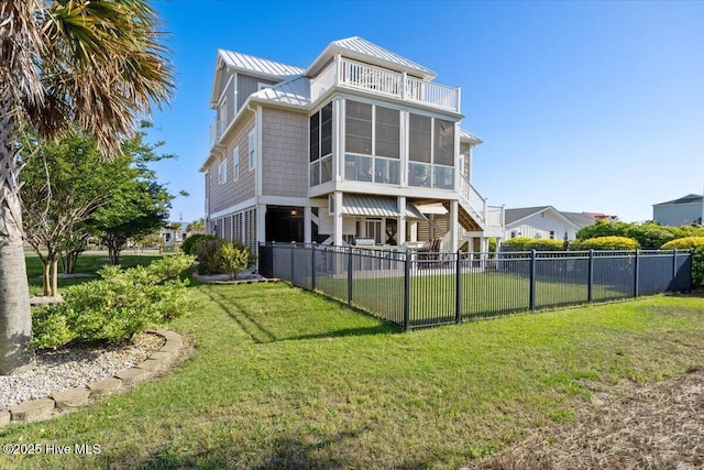 1 Gatha Ln, Ocean Isle Beach, NC 28469 - rear view of house with a sunroom, a fenced backyard, a balcony, a standing seam roof, and metal roof