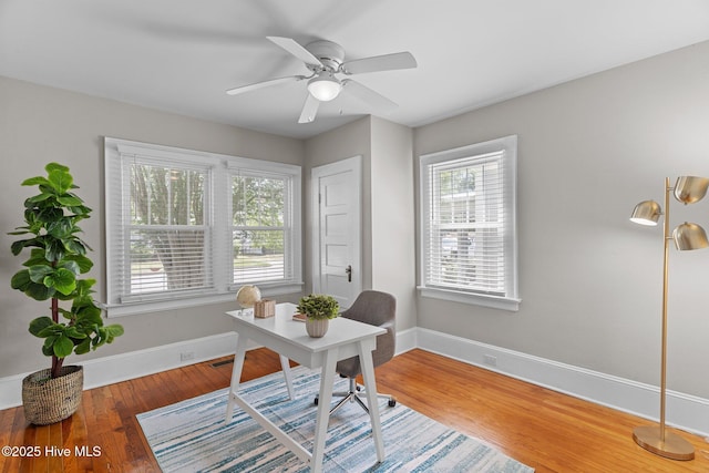 office featuring baseboards, a ceiling fan, and wood finished floors