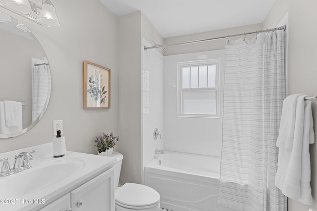 full bathroom featuring vanity, shower / bath combo with shower curtain, and toilet