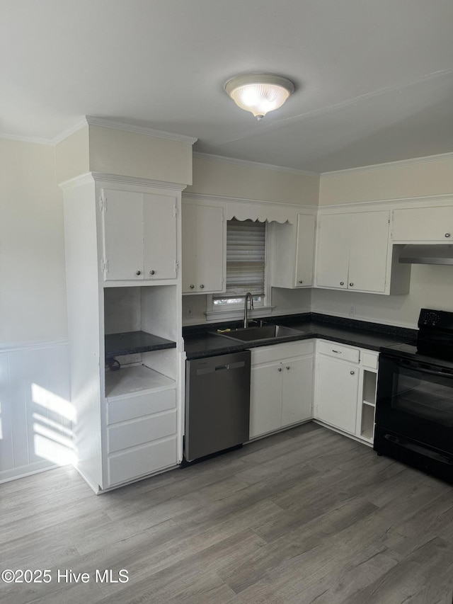 kitchen featuring under cabinet range hood, dark countertops, stainless steel dishwasher, black range with electric stovetop, and a sink