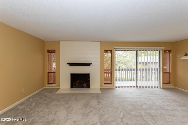 250 Sugar Gum Ln Unit 156, Pinehurst, NC 28374 - unfurnished living room with baseboards, carpet flooring, and a fireplace