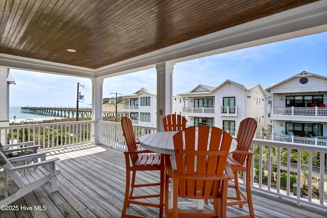 wooden terrace featuring a water view