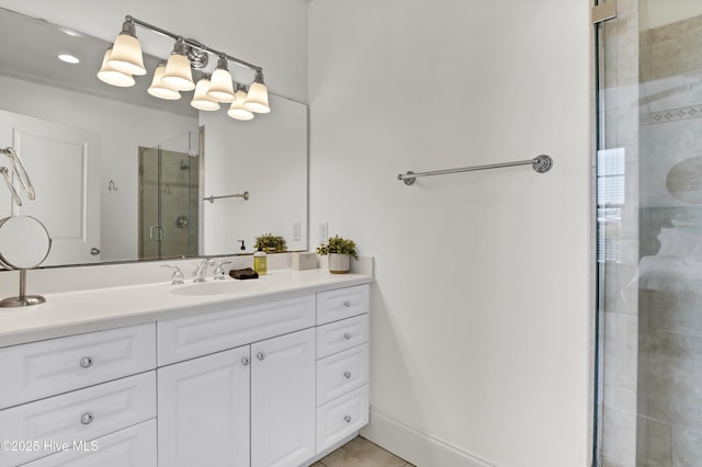 full bath with vanity, tile patterned flooring, and a stall shower