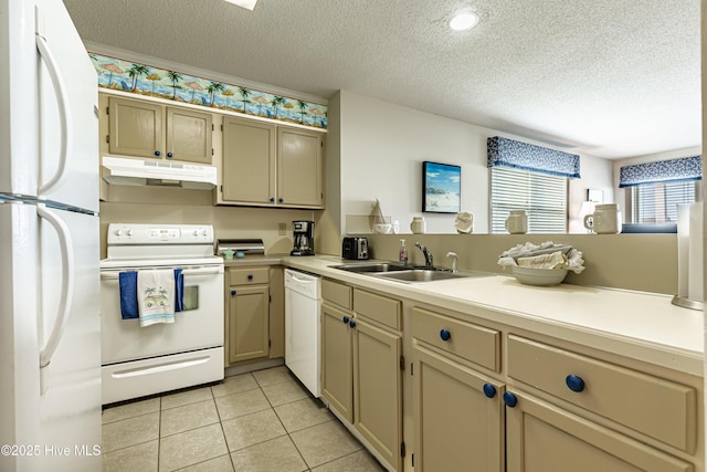 kitchen with light countertops, a textured ceiling, under cabinet range hood, and white appliances