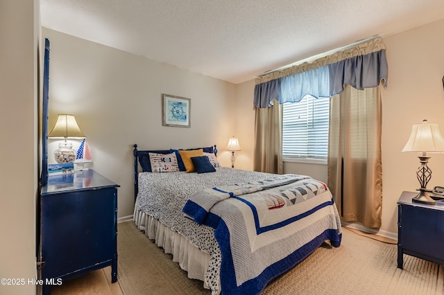bedroom with baseboards and light wood finished floors