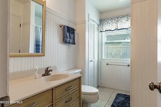 full bath featuring tile patterned floors, toilet, and vanity